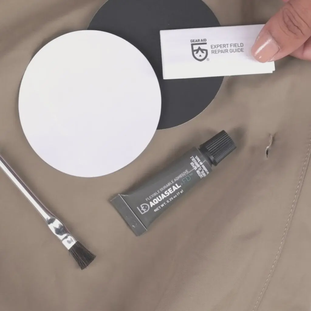 Gear Aid AquaSeal FD Repair Kit for waterproofing and gear repair, featuring various tools and sealants in a compact kit.