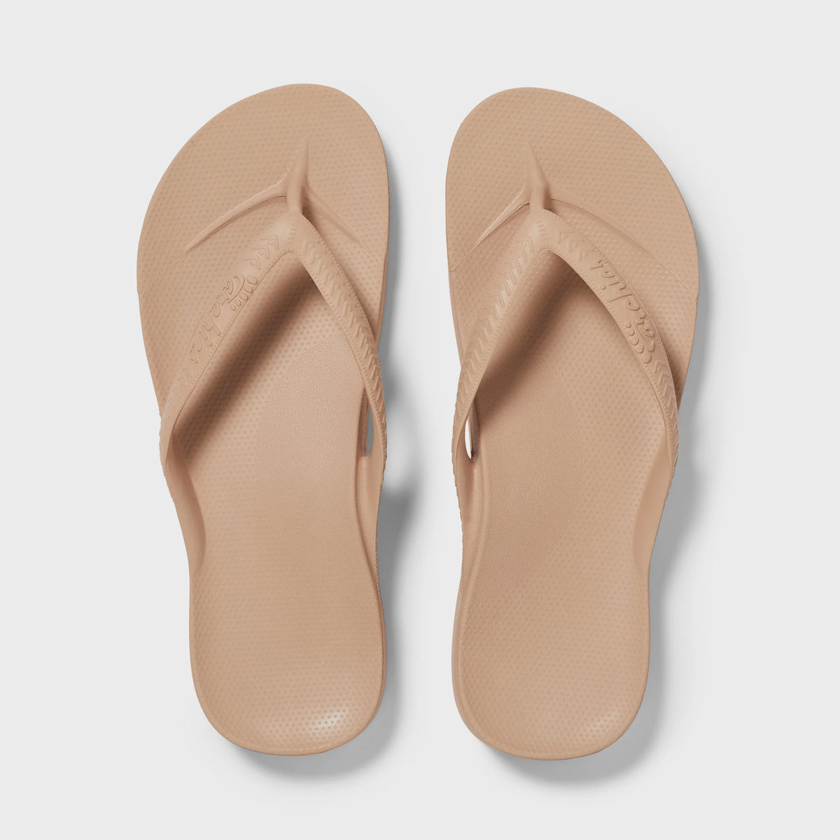 Hot pink Archies Arch Support Thong sandal showcasing comfortable footbed and stylish design on a flat surface.