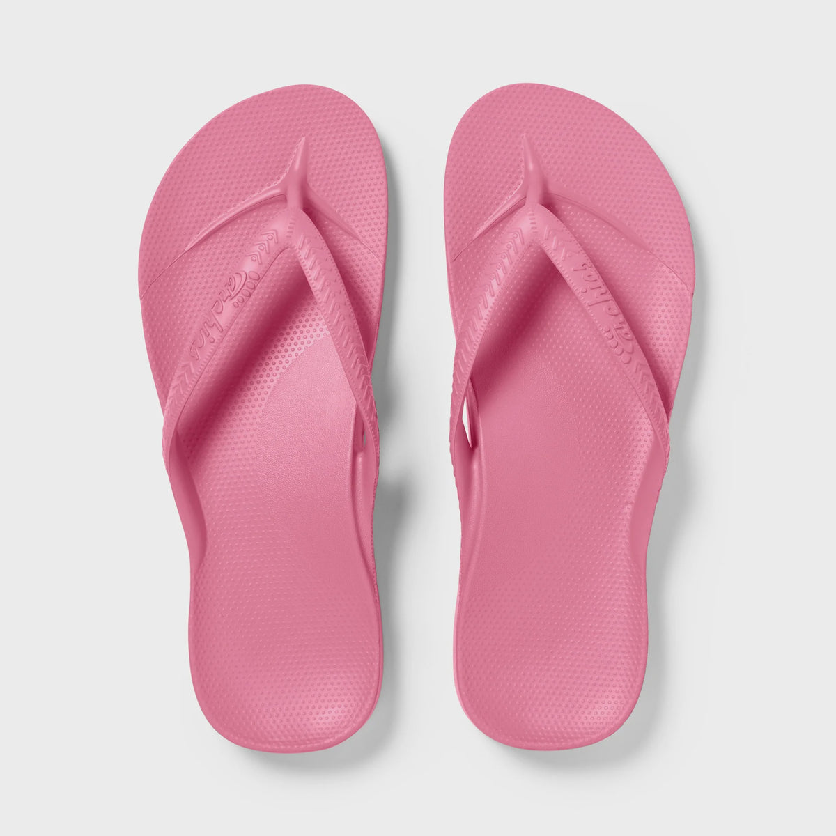 Hot pink Archies arch support thong footwear with cushioned sole and ergonomic design for comfortable wear.